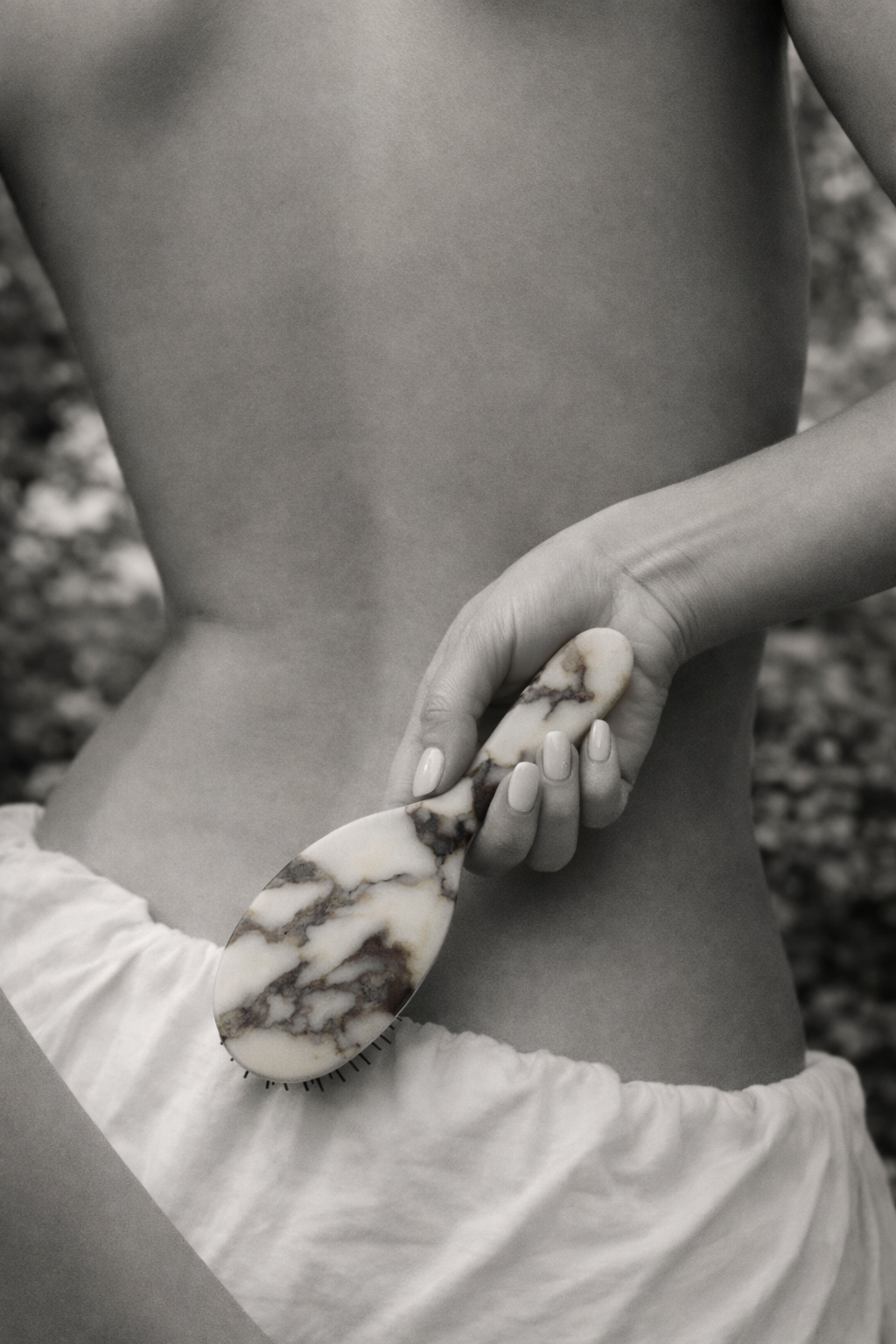 Person holding a marbled brush against their skin outdoorsslider_item_ytrt6i